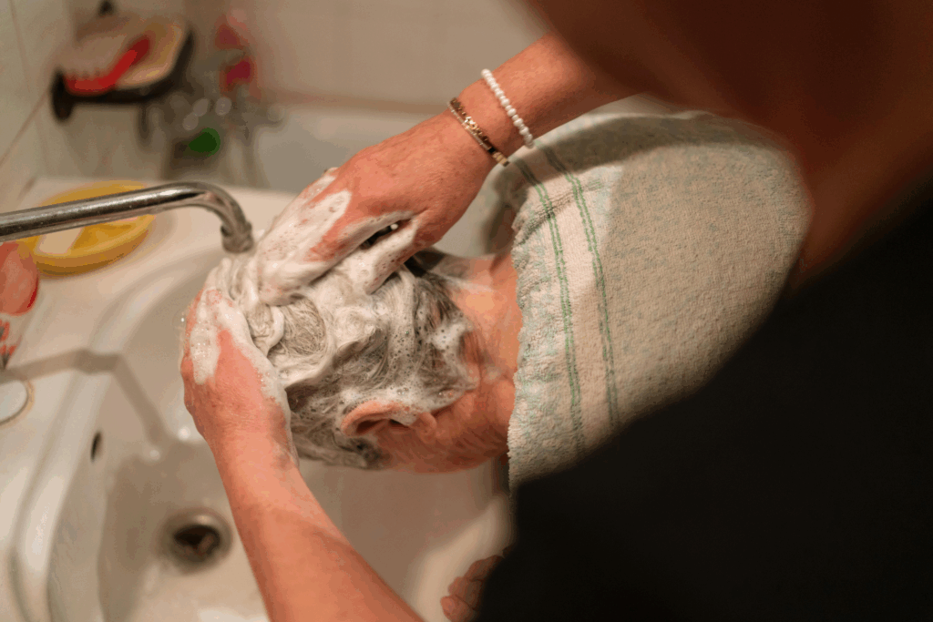 Caregiver giving a senior a hair wash during live-in care in Wyckoff