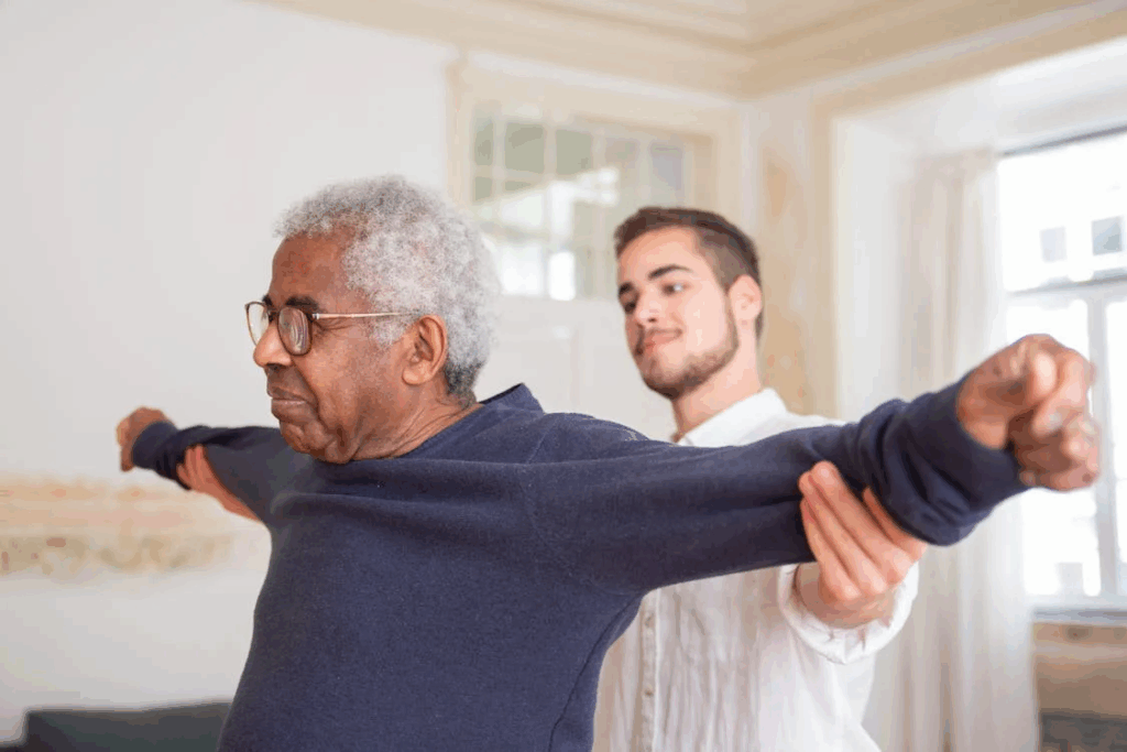 An elder being taken care for by a young man.