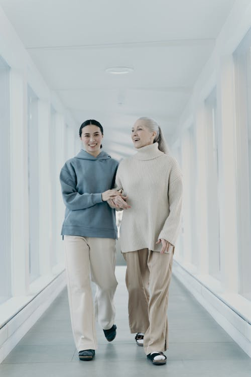 Elderly woman walking safely in a clear hallway