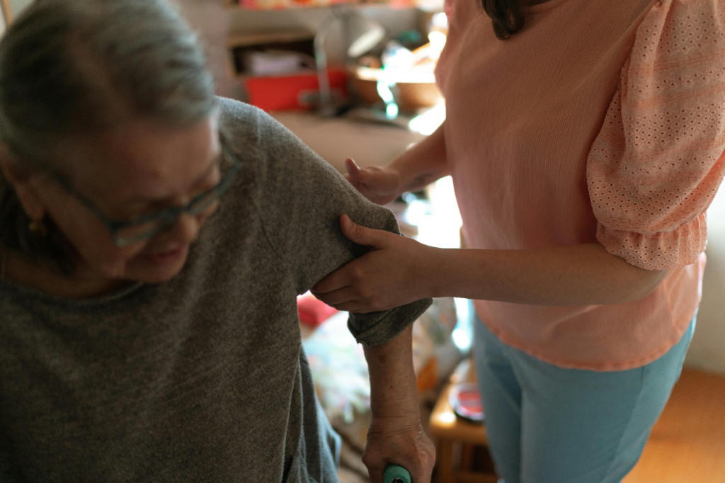 A senior standing up with support