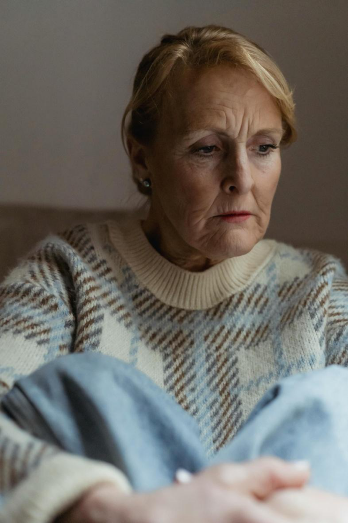 An elderly woman feeling sad