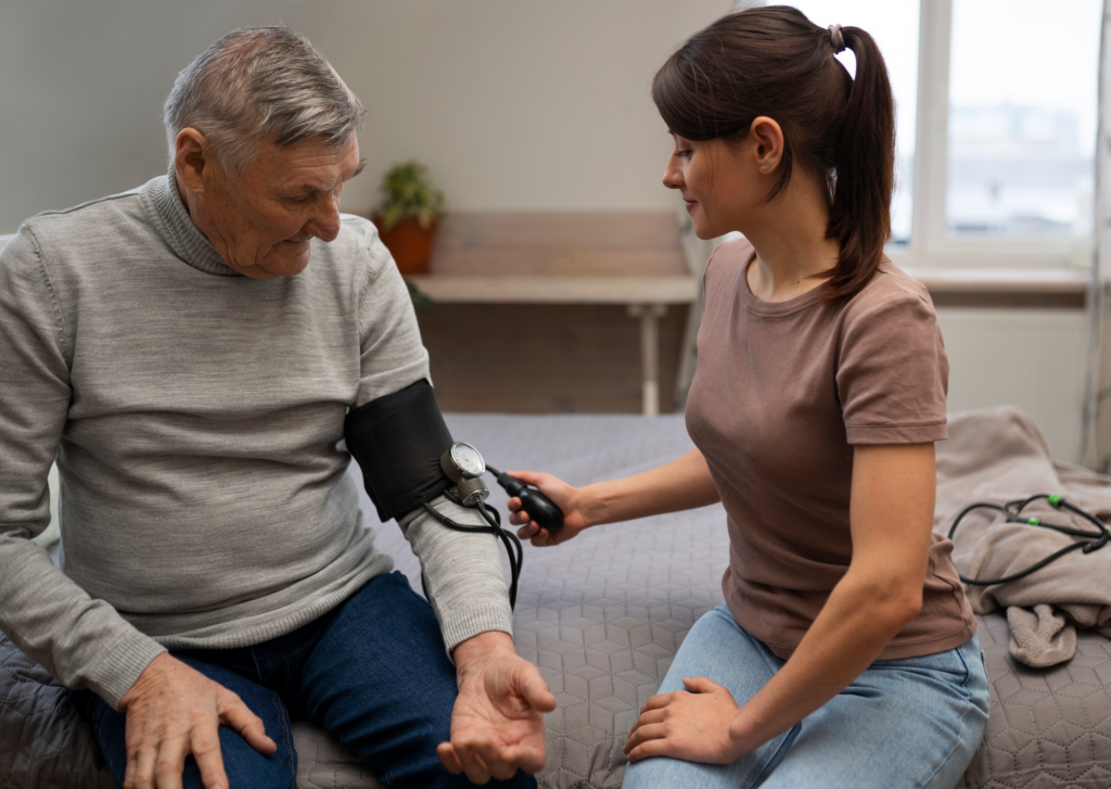 A caregiver using a blood pressure apparatus on an elderly person