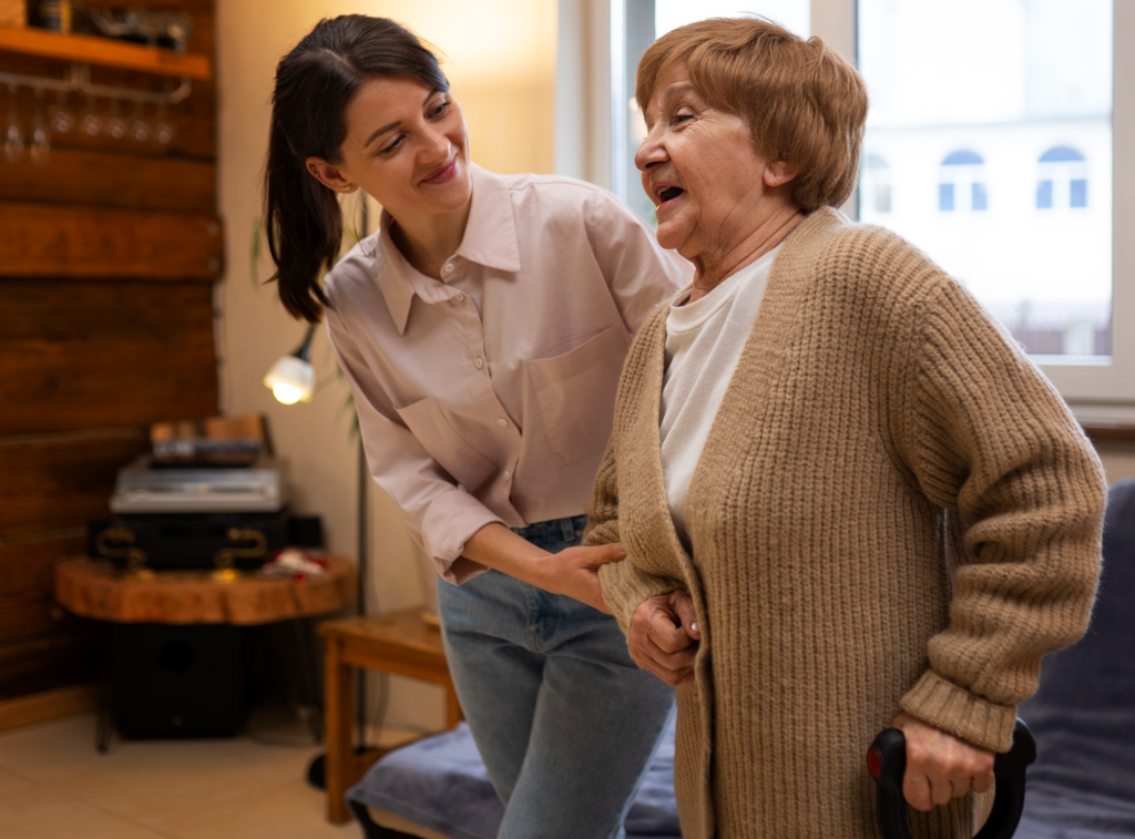 A caregiver helping an elderly person walk