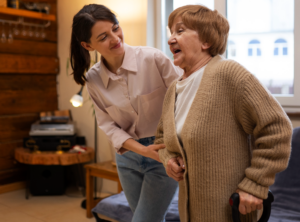 A caregiver helping an elderly person walk