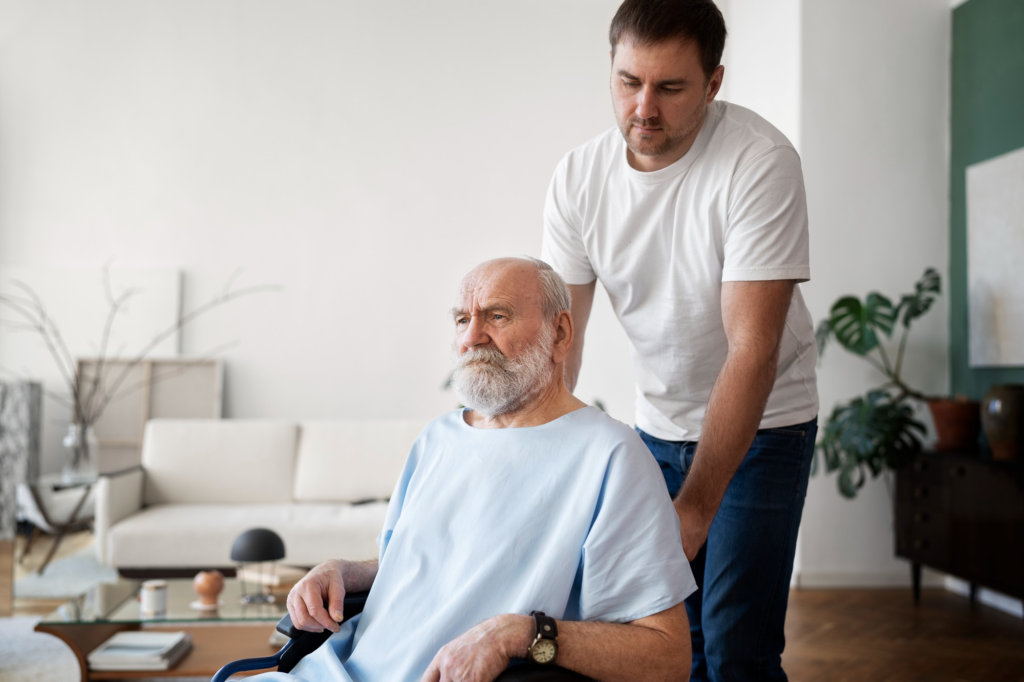 A caregiver pushing the wheelchair of an elderly person