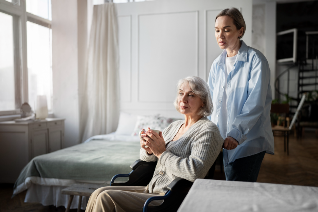 A caregiver pushing the wheelchair of an elderly person