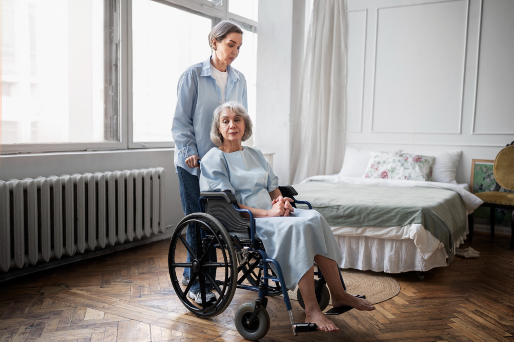 A caregiver pushing an elderly person's wheelchair