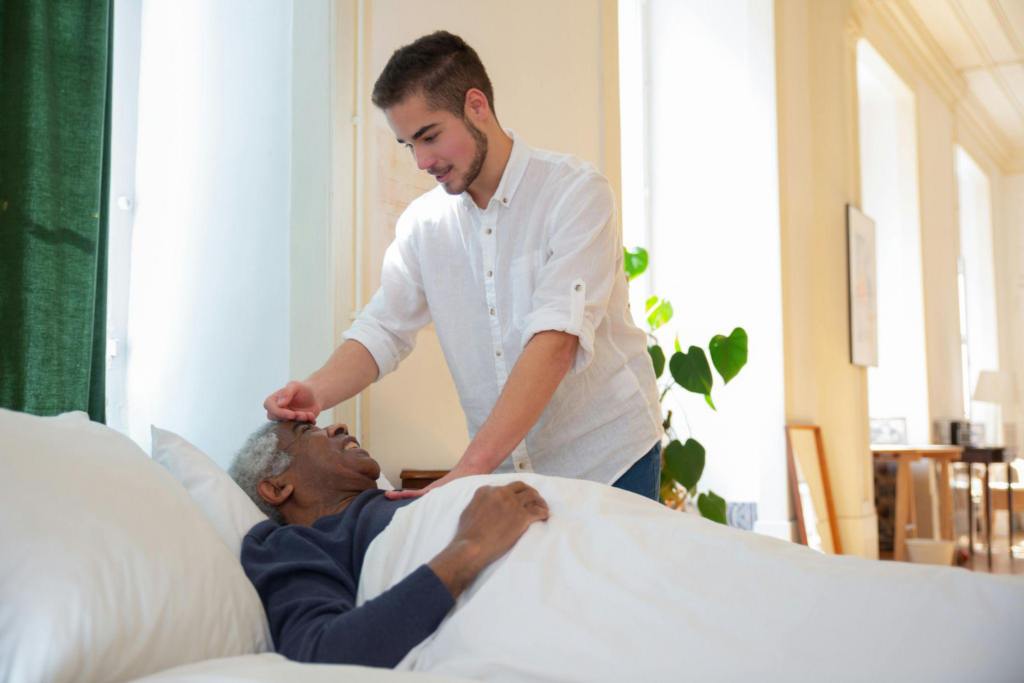 a caregiver checking an elderly person’s temperature