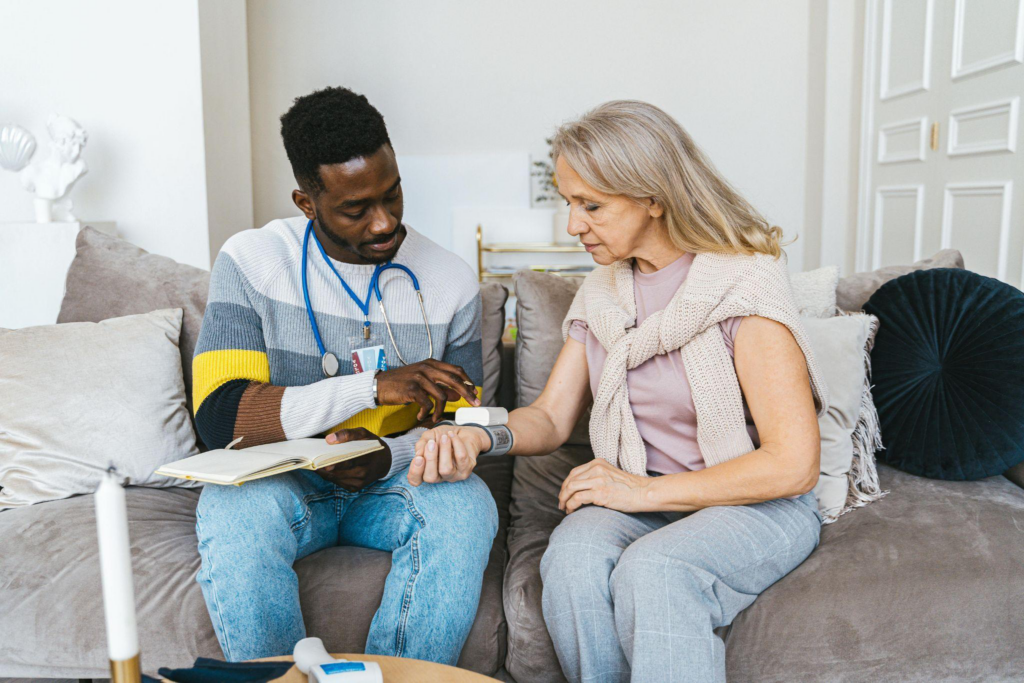 a caregiver checking an elderly person’s vitals